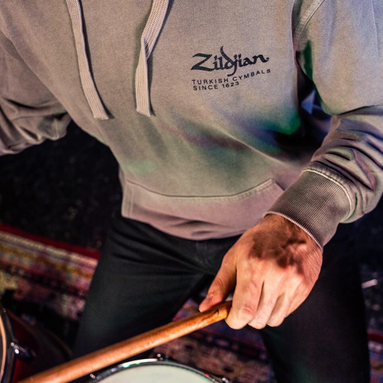 Man drumming in Pewter limited edition hoodie